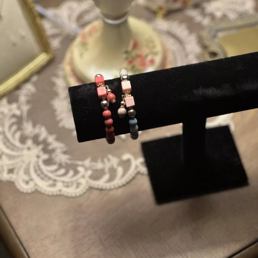 pink and light pink beaded bracelets.